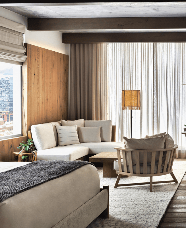 Dark toned bedroom with seating area in corner