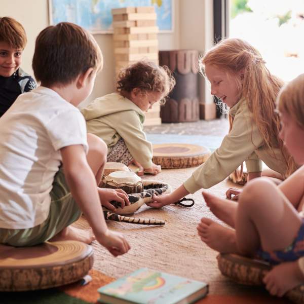 Children sitting on the floor playing quietly with toys inside a cozy room