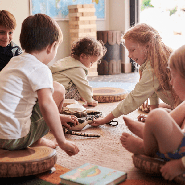 Children sitting on the floor playing quietly with toys inside a cozy room