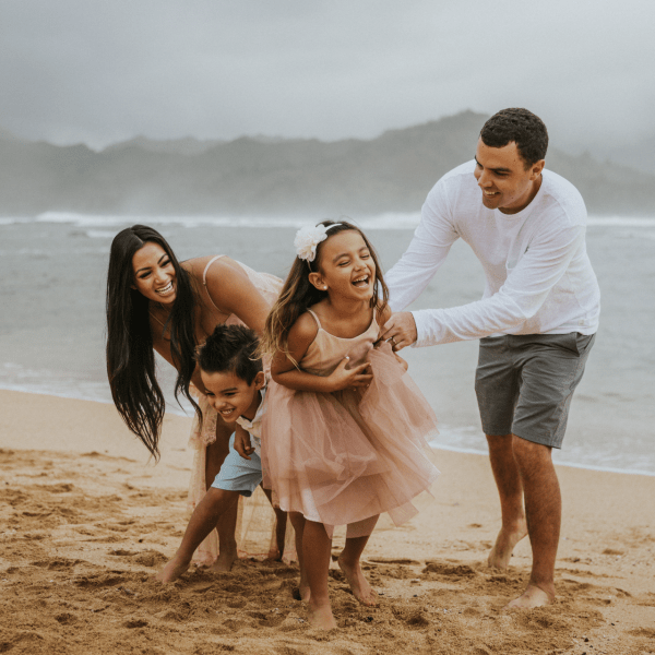 Family on beach doing a photoshoot