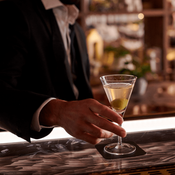 man drinking a cocktail at the bar