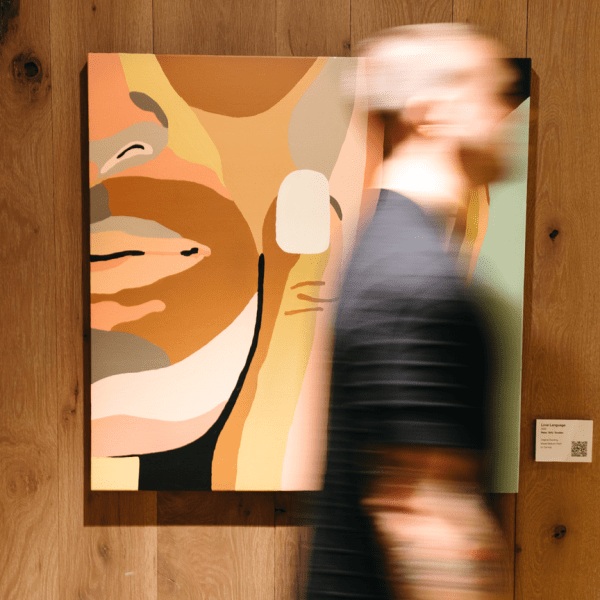 Person quickly walking by a piece of art