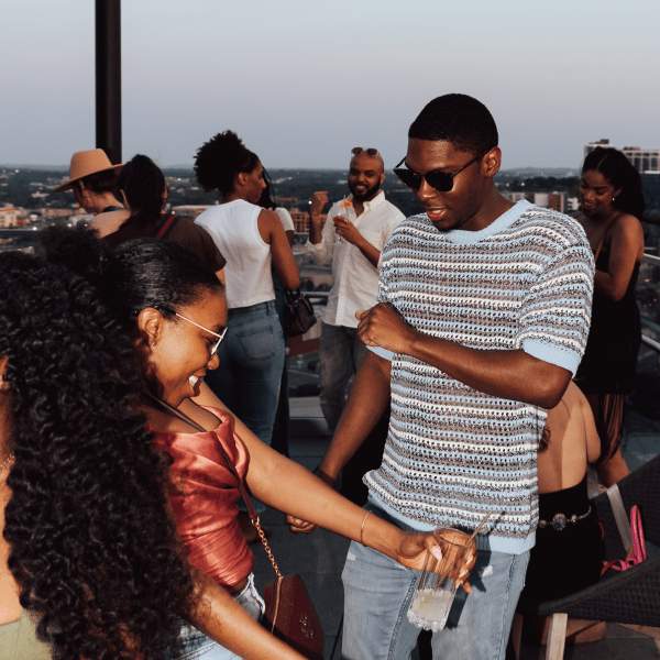 friends dancing on a rooftop