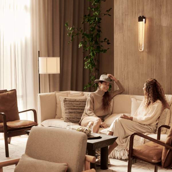 Two women sit in West Lounge