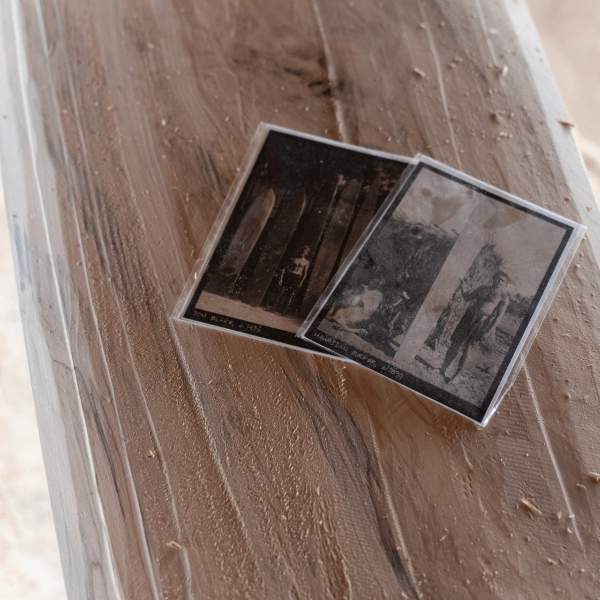 Two black and white photos of surfers