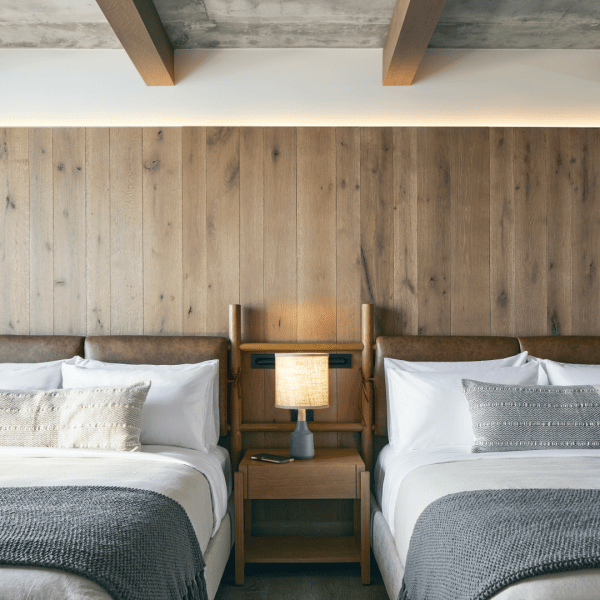 Two double beds with wooden headboards sit side by side