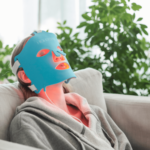 A woman at the spa getting a facial mask