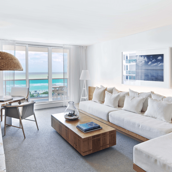 Living room with a sectional couch, coffee table and desk
