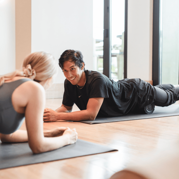 Two people foam rolling class