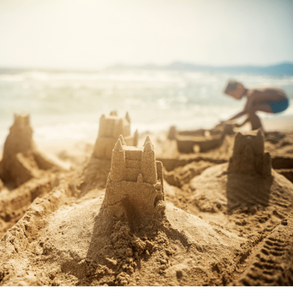 Children building a sandcastle on the beach