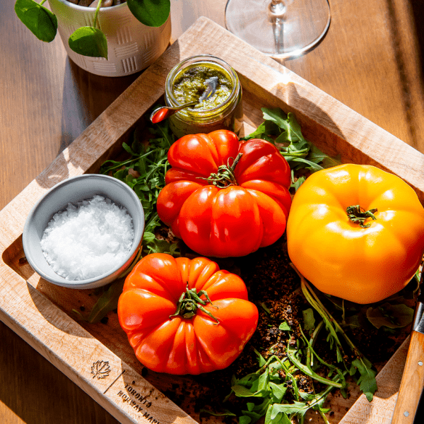 Tomatoes on a board with salt