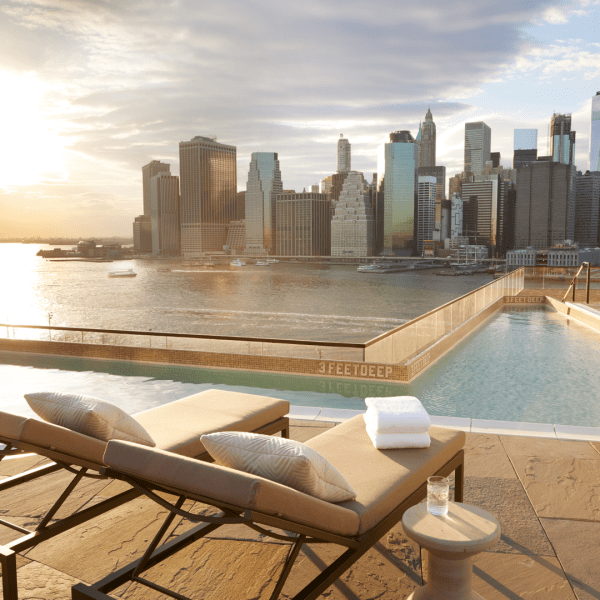 Two lounge chairs on the edge of a pool
