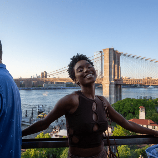 Person smiling with the Brooklyn Bridge in the background
