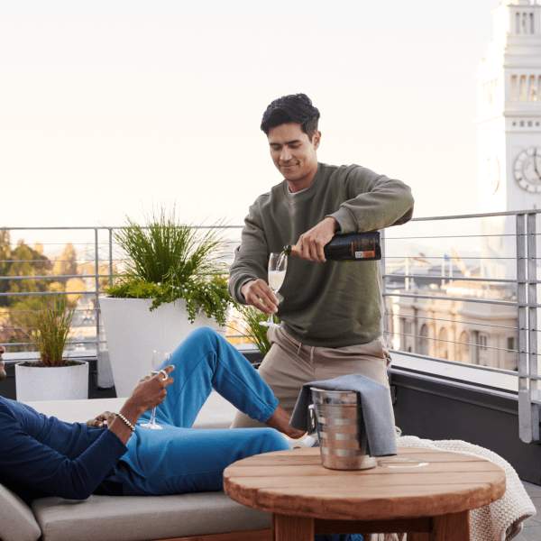 two people drinking champagne on a patio