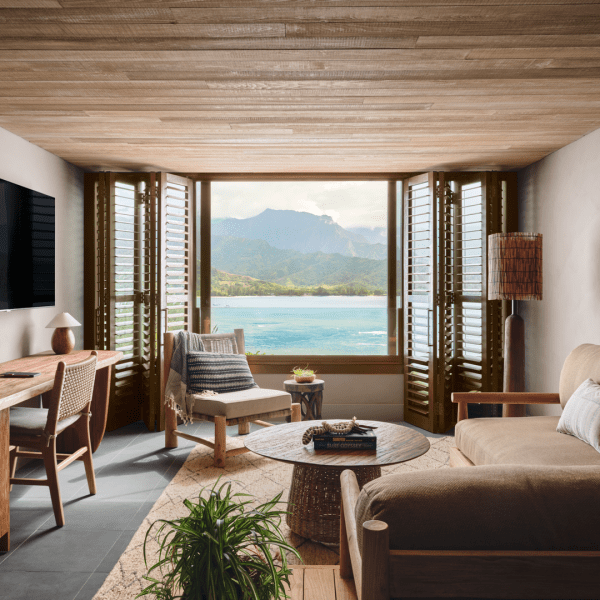 Living area with a deep sectional couch and a window looking out to the water