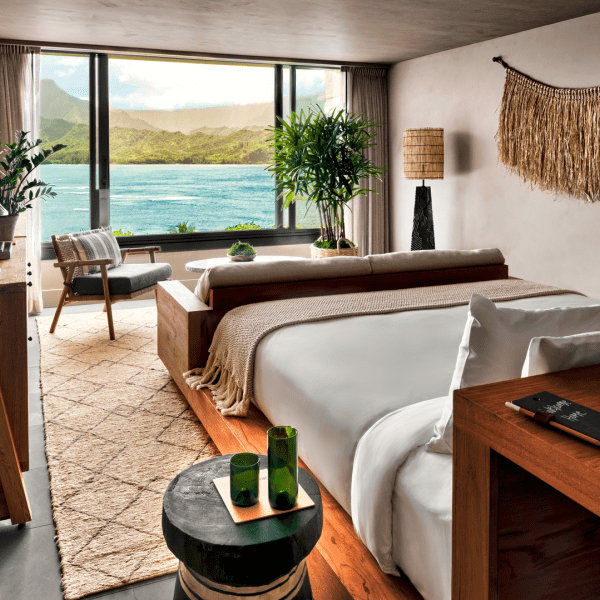 A bedroom with a view of the ocean just outside