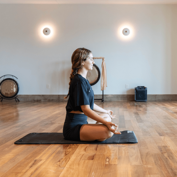 Person meditating on a yoga mat