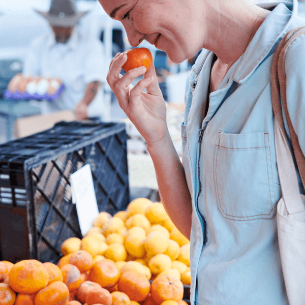 Person smelling a tangerine