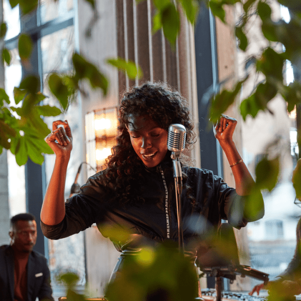 Person singing and dancing in front of a microphone