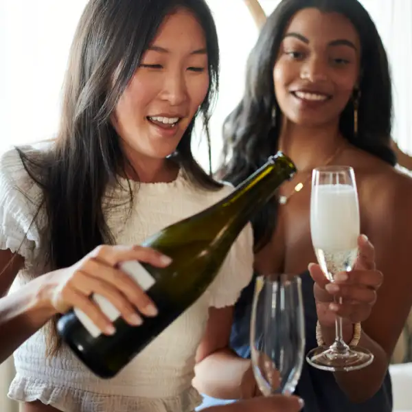 Women pouring champagne