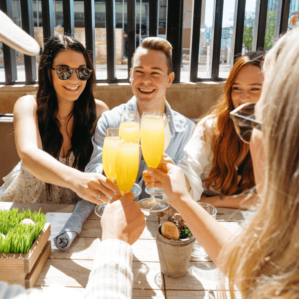 friends enjoying mimosas outside