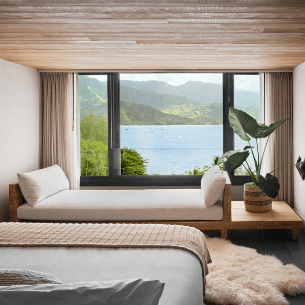 A hotel room with a view of the ocean just outside