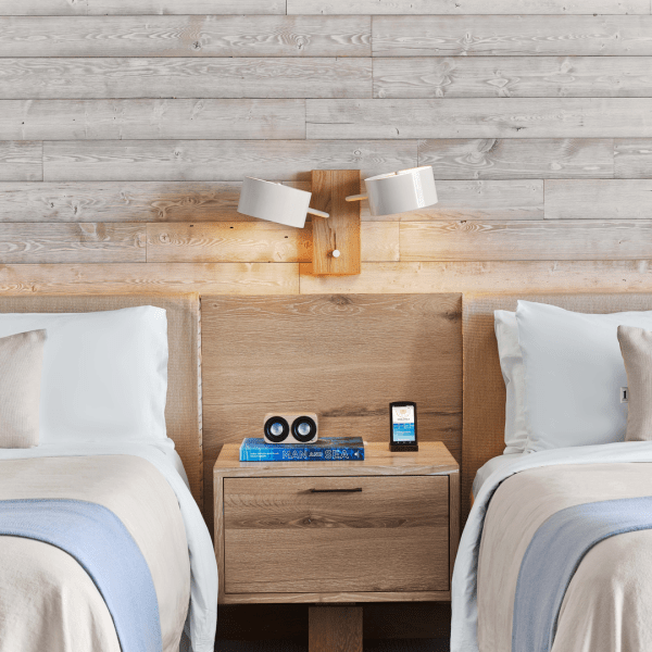 Two beds next to each other with a side table in the middle