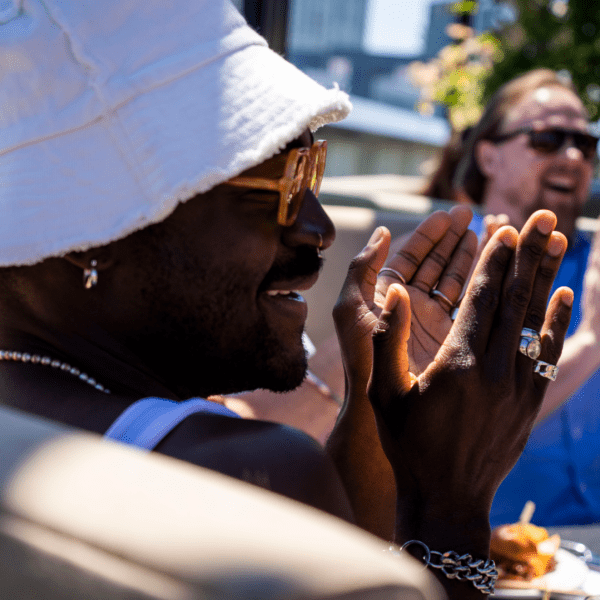 Person wearing a bucket hat clapping