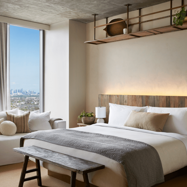 A king size bed with a white sofa adjacent 