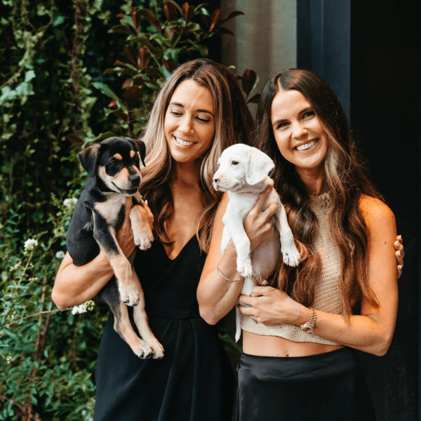 Women holding puppies