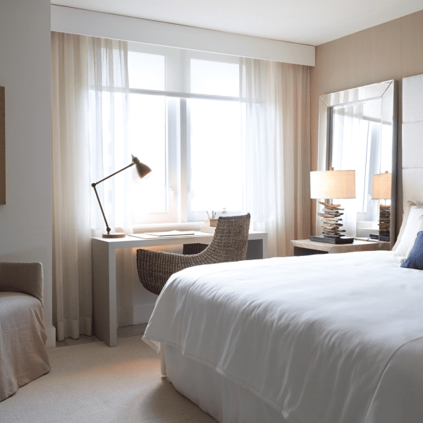 A desk with a lamp in a bedroom