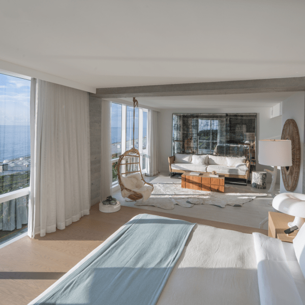 Presidential Suite for 1 Hotel South Beach complete with panoramic views of the water and a fully furnished living room area adjacent to the king size bed