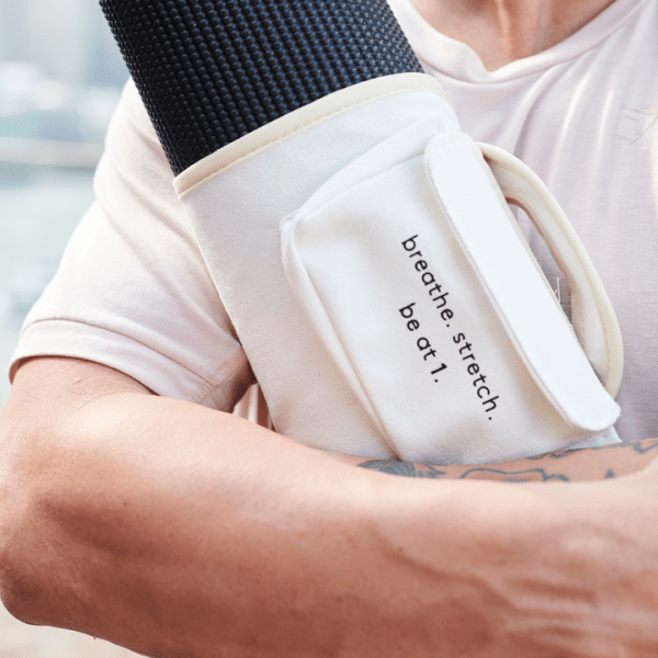 Person holding yoga matt