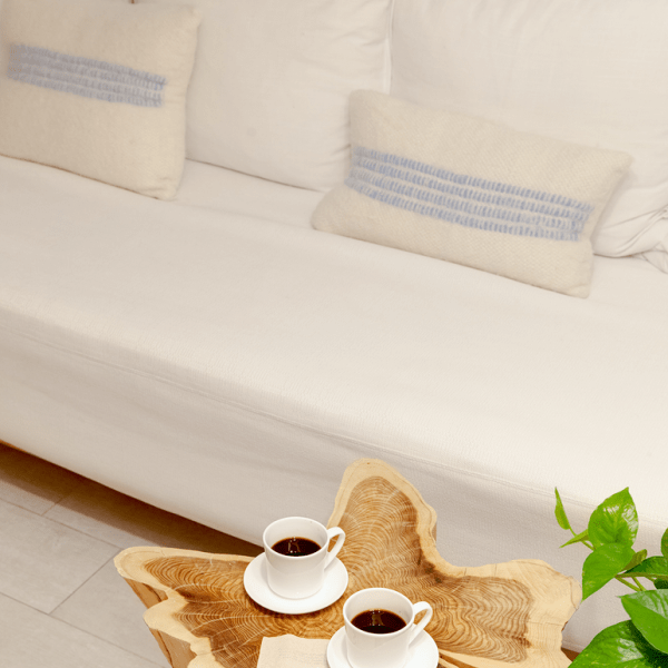 Two cups of coffee resting on a live edge coffee table