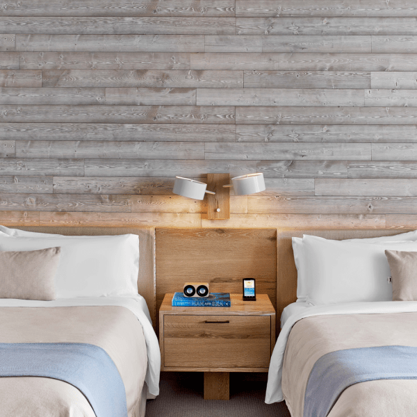 Two queen beds with a wooden side table in between