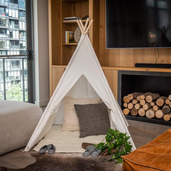 A small canvas tent set up in a living area of a suite at 1Hotel