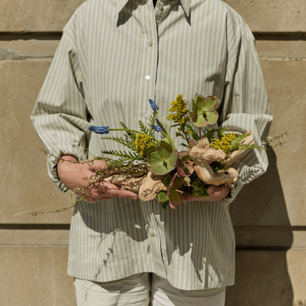 person with floral arrangement