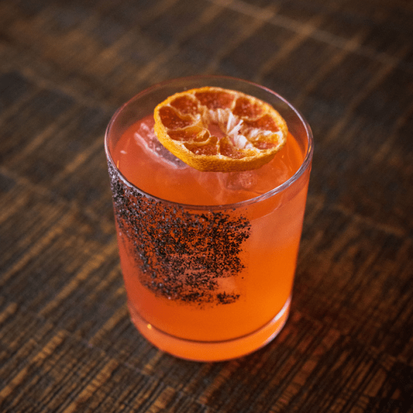 Orange cocktail with salt rim on the side of the glass