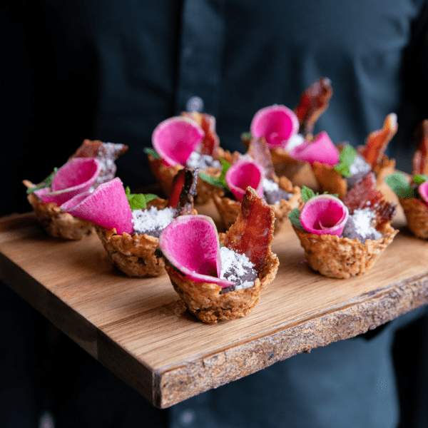Appetizers displayed on a wooden cutting board