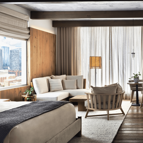 Dark toned bedroom with seating area in corner