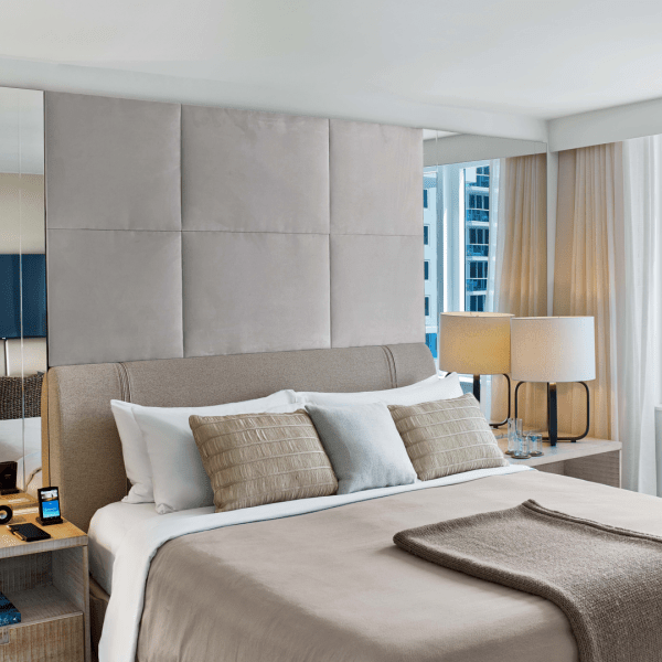 A made bed with two side tables