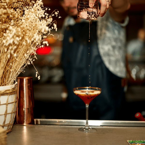 A bartender mixing a cocktail 