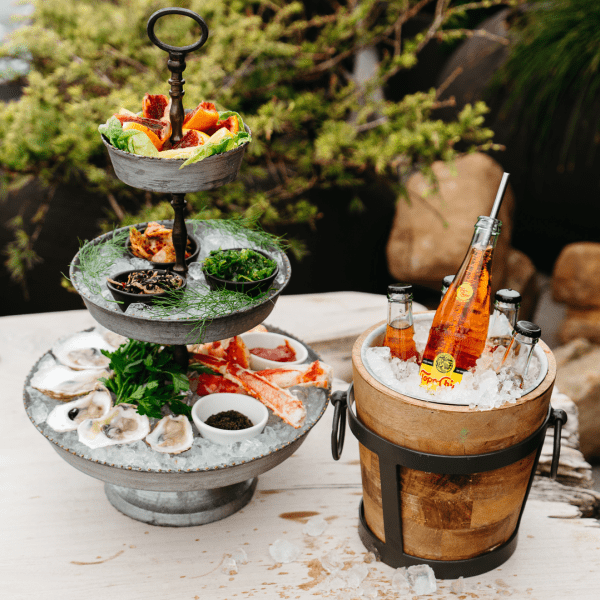 A platter of seafood and an ice chest with drinks
