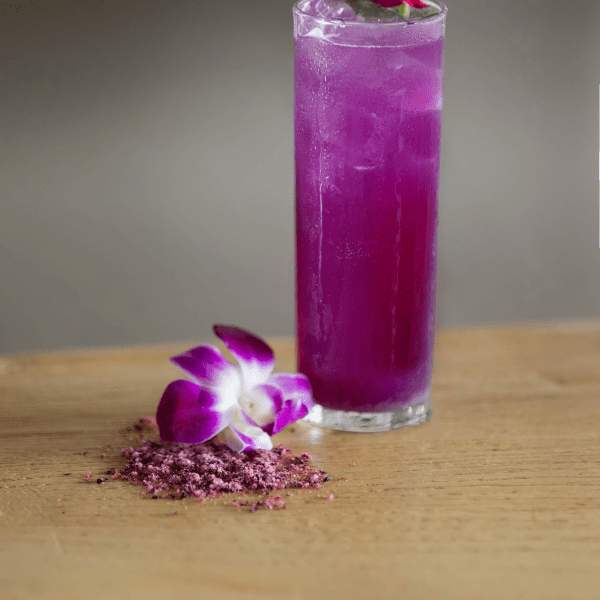 purple cocktail in tall glass