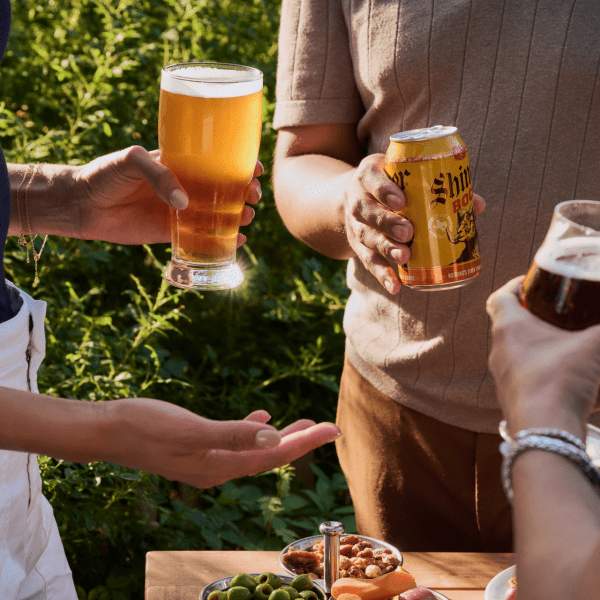 3 people holding beers in barbuto garden