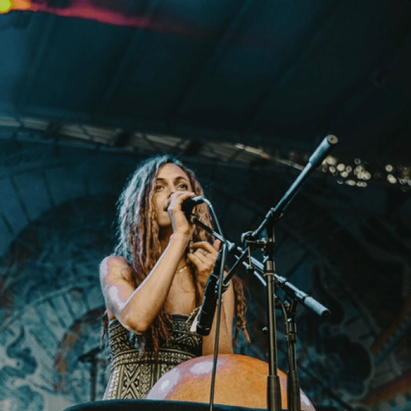 Person singing into a mic on stage
