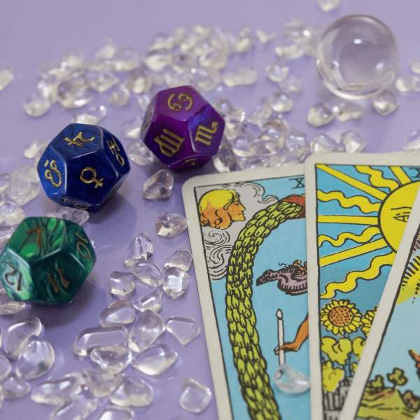 Tarot cards and three twelve-sided die