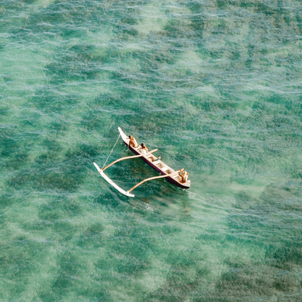 People on an outrigger on the water