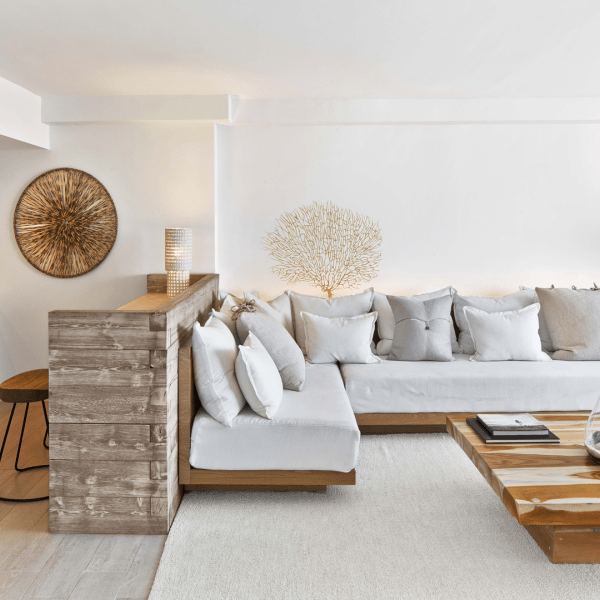 Living room with a sectional couch, coffee table and bar stools