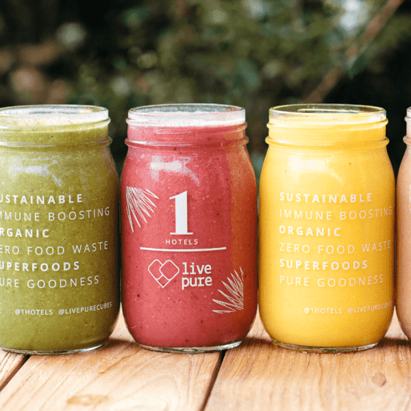 Four mason jars with smoothies lined up